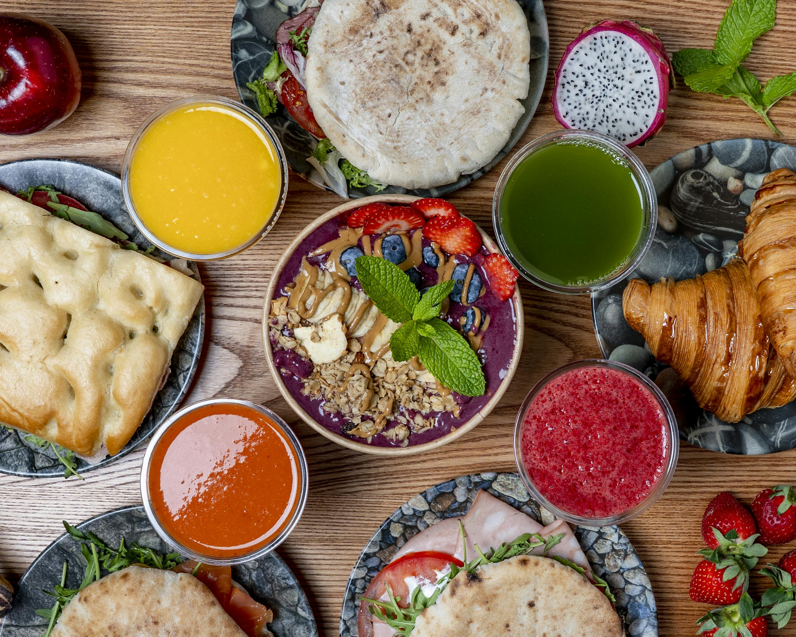 Vibrant breakfast spread featuring smoothies, pastries, and fresh fruits. Perfect for a healthy start.