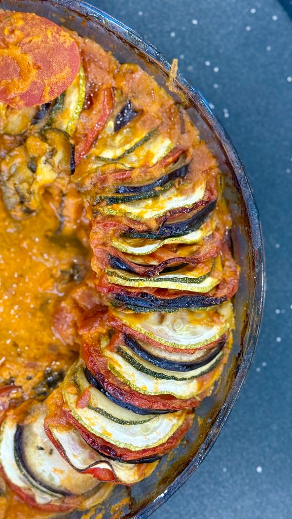A delicious and vibrant ratatouille dish featuring layers of sliced vegetables in a tomato sauce.