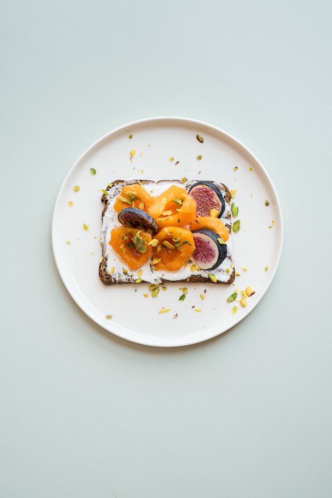 A stylish gourmet toast topped with figs, apricots, and nuts, ideal for breakfast.