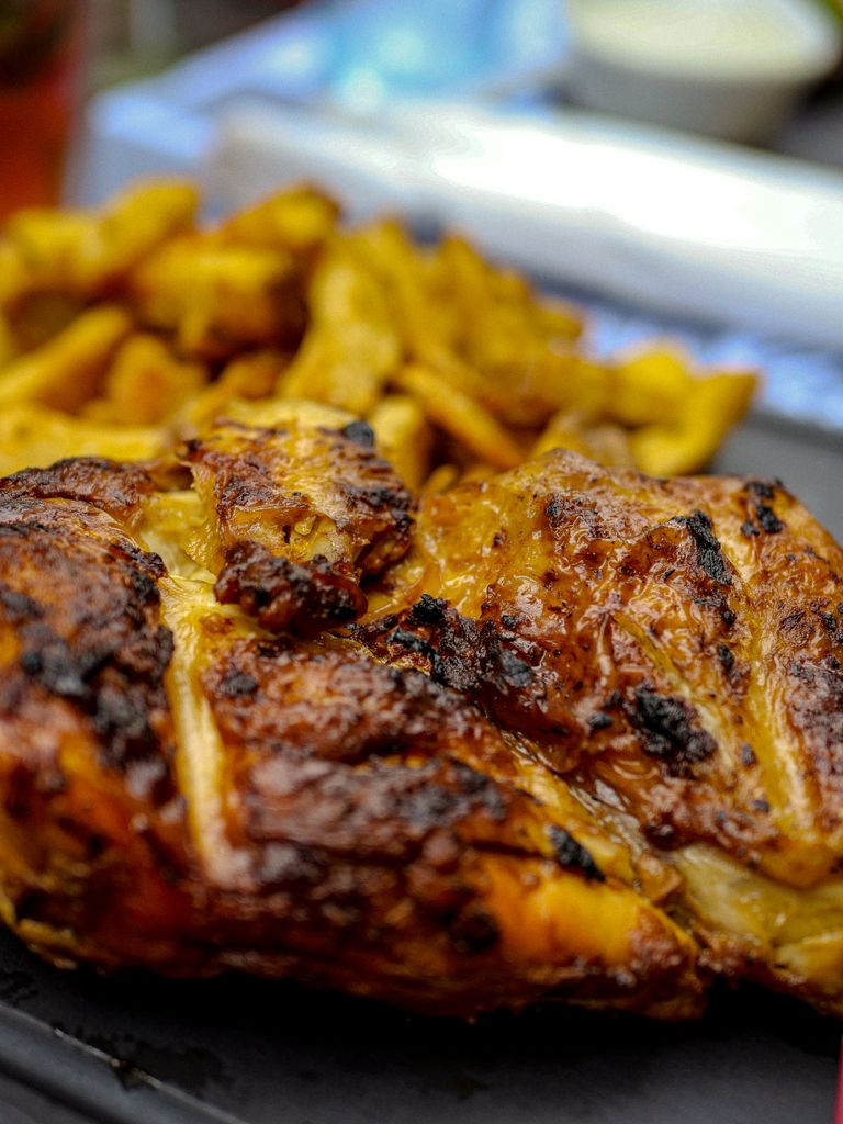 Delicious close-up of grilled chicken with fries, capturing the flavors in Montpellier, France.