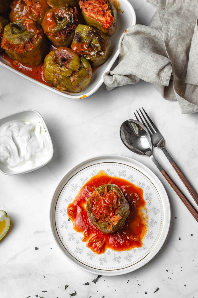 Savor the flavor of stuffed bell peppers served with rich tomato sauce. Perfect for a hearty meal.