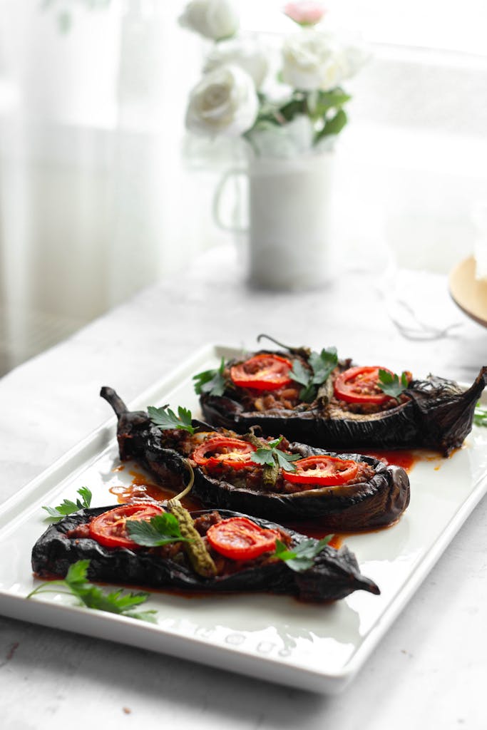 Savory homemade stuffed eggplants garnished with tomato and parsley, perfect for a hearty meal.